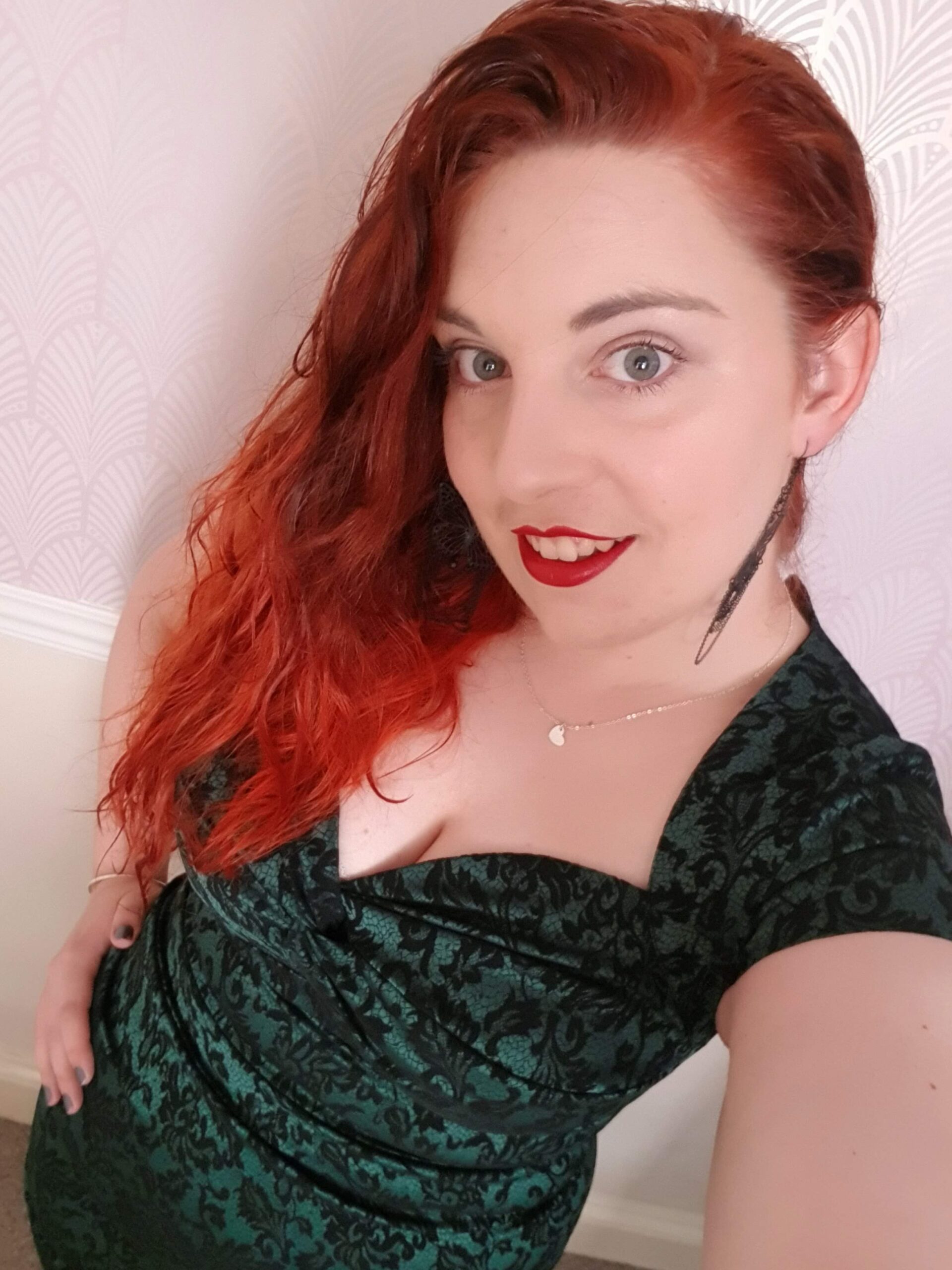 Selfie of me with red hair, wearing a green dress